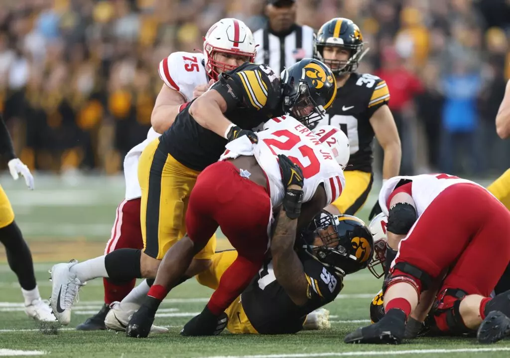 Nov 25, 2022; Iowa City, Iowa, USA; Iowa Hawkeyes linebacker Jack Campbell (31) tackles Nebraska Cornhuskers running back Gabe Ervin Jr. (22) at Kinnick Stadium. Mandatory Credit: Reese Strickland-USA TODAY Sports