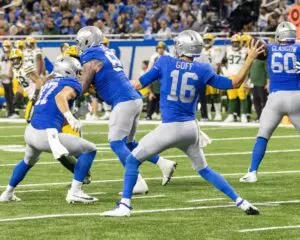 Home 11 Detroit Lions Quarterback Jared Goff (16) in the historic throwbacks steps back to throw the ball to a receiver down field on Thanksgiving at Ford Field in Detroit, Michigan.