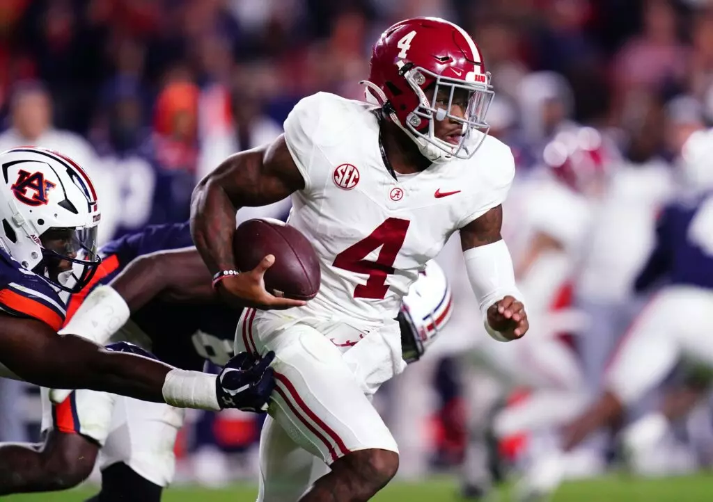 Nov 25, 2023; Auburn, Alabama, USA; Alabama Crimson Tide quarterback Jalen Milroe (4) scrambles out of the pocket against the Auburn Tigers during the fourth quarter at Jordan-Hare Stadium. Mandatory Credit: John David Mercer-USA TODAY Sports