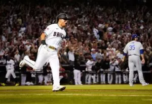 Home 14 Arizona Diamondbacks' (white) Gabriel Moreno (14) hits a home run in the NLDS Game Three