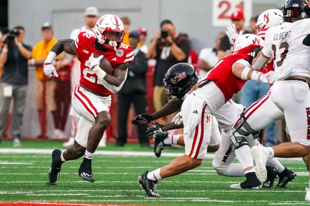Nebraska Cornhuskers running back Gabe Ervin Jr running down the field, avoiding Northern Illinois defenders at Memorial Stadium.