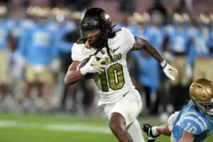 Colorado Buffaloes wide receiver Xavier Weaver (10) carries the ball against the UCLA Bruins in the second half at Rose Bowl. UCLA defeated Colorado 28-16.