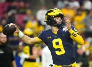 Home 13 Michigan quarterback JJ McCarthy (9) throws a pass during the pregame before the Fiesta Bowl at State Farm Stadium.