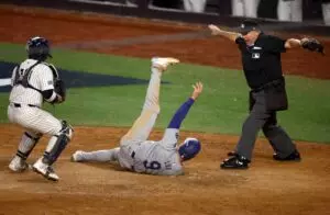 Home 5 MLB home plate umpire Mark Carlson calls Los Angeles Dodgers second baseman Gavin Lux (9) safe against New York Yankees catcher Jose Trevino (39) during the sixth inning in game three of the 2024 MLB World Series at Yankee Stadium.