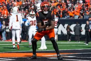 Home 9 Cincinnati Bengals wide receiver Tee Higgins (Orange helmet, black jersey, orange pants) catches and celebrates a touchdown. Higgins will be a top free agent in the 2025 free agency.