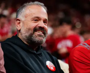 Home 1 Nebraska football head coach Matt Rhule smiles while sitting on the sideline at the Nebraska-Creighton basketball game at Pinnacle Bank Arena in Lincoln, NE