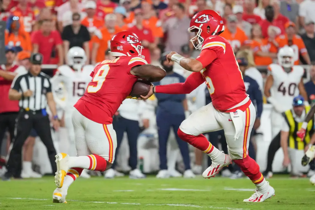 Patrick Mahomes handing it off to Kenneth Walker, forcing defenses to rethink how they attack Mahomes