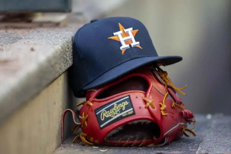 A general view of a Houston Astros hat and glove in the dugout. Who do you think could be the next Astros manager?