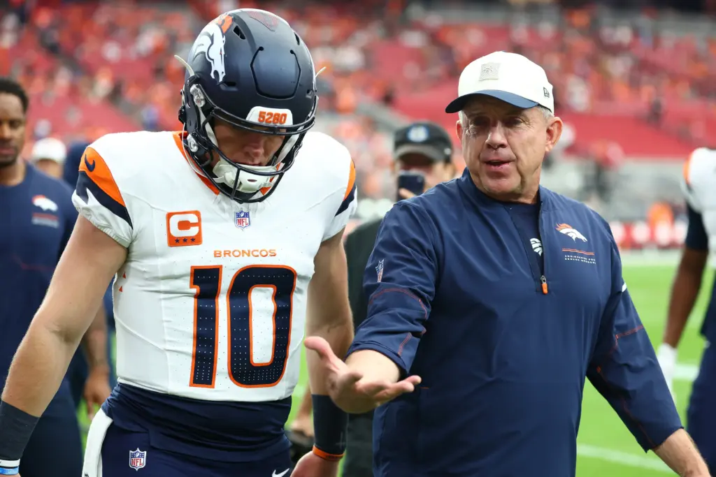 Sean Payton walks with Bo Nix